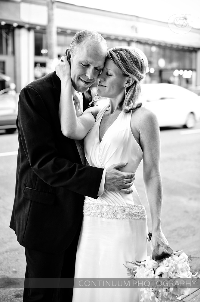 Sweet black & white wedding portrait of bride and groom outside on Alberta St. in Portland.