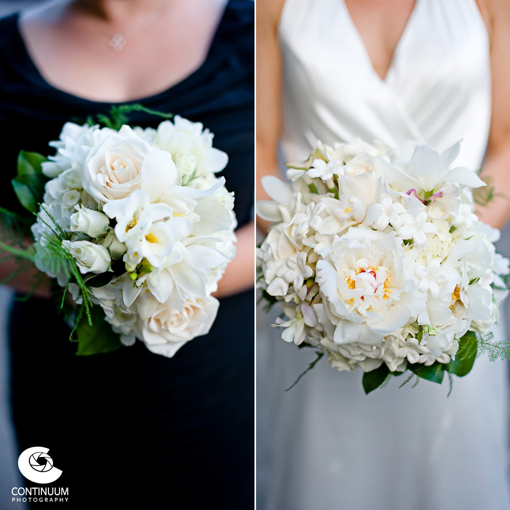 Bridal boquet and bridesmaid boquet featuring white roses and other white flowers.