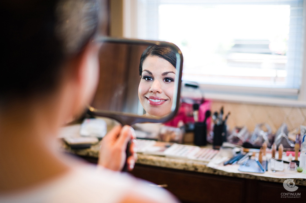 bride checks out the work of Cynthia Sally in the mirror