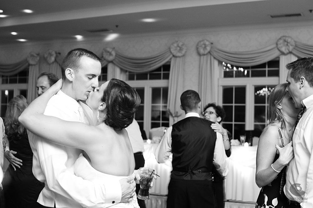 married couple kiss on the dance floor of ruffled feathers