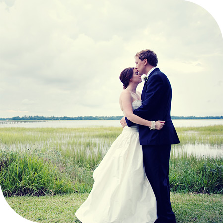 Photo of bride & groom kissing at their wedding at Lowndes Grove by their Charleston Wedding Photographer.