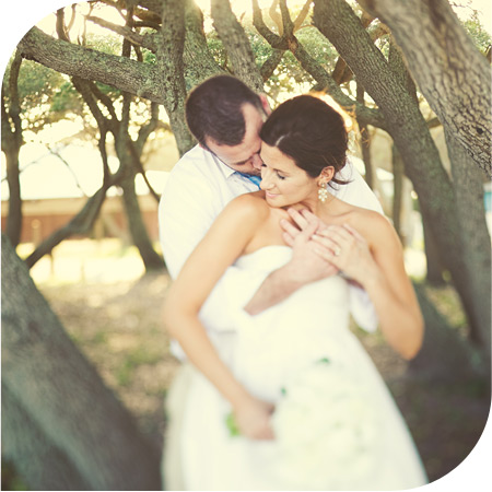 Real San Diego beach wedding photo of bride and groom embracing on the dunes off La Jolla, CA.